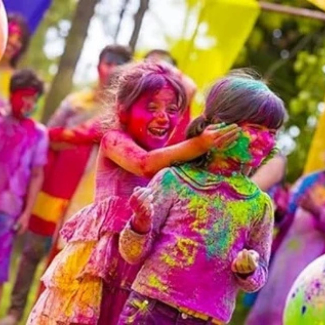 Friends celebrating Holi festival with colorful gulal powder