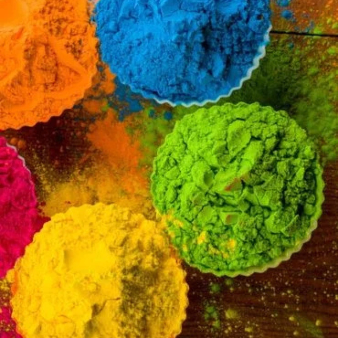Vibrant Holi gulal powder in orange, blue, green, yellow and pink